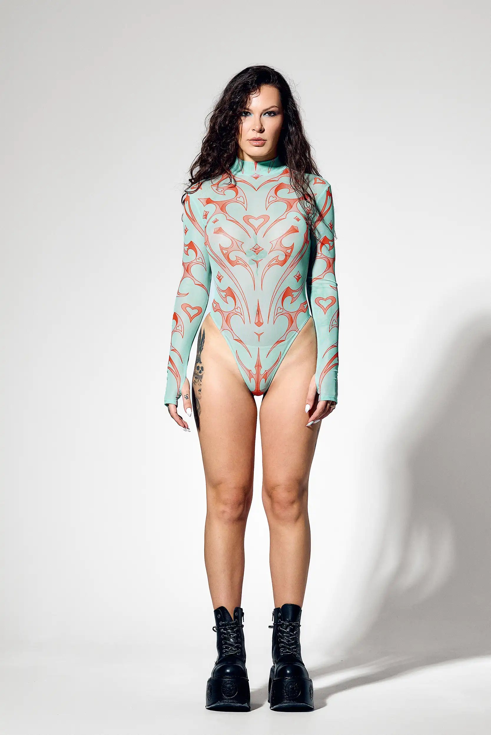 Futuristic ravewear bodysuit made from fine elastic mesh with four-way stretch.