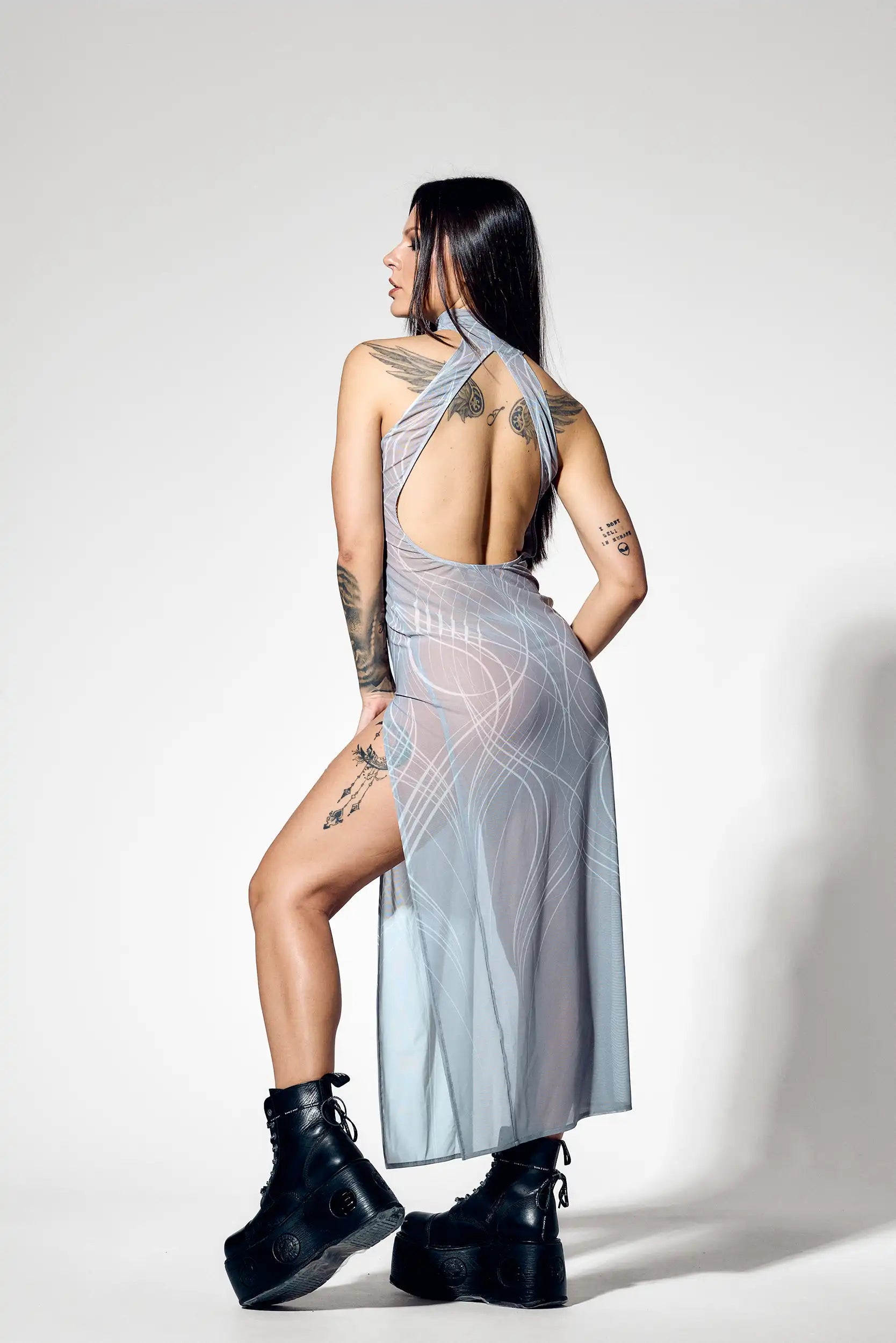 Back view of sheer gray maxi dress with dramatic open back