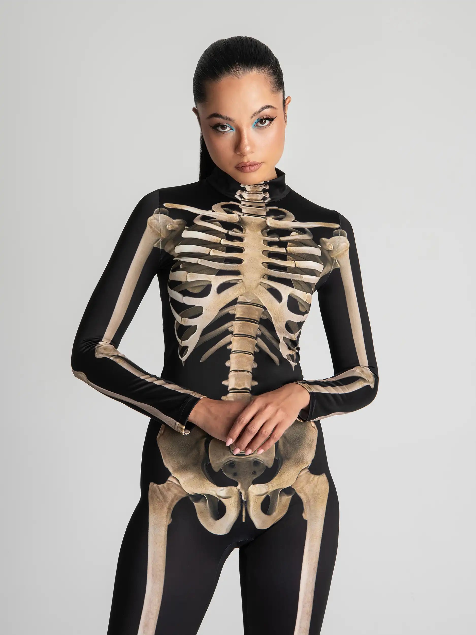 Person wearing a black bodysuit with skeleton design on a gray background