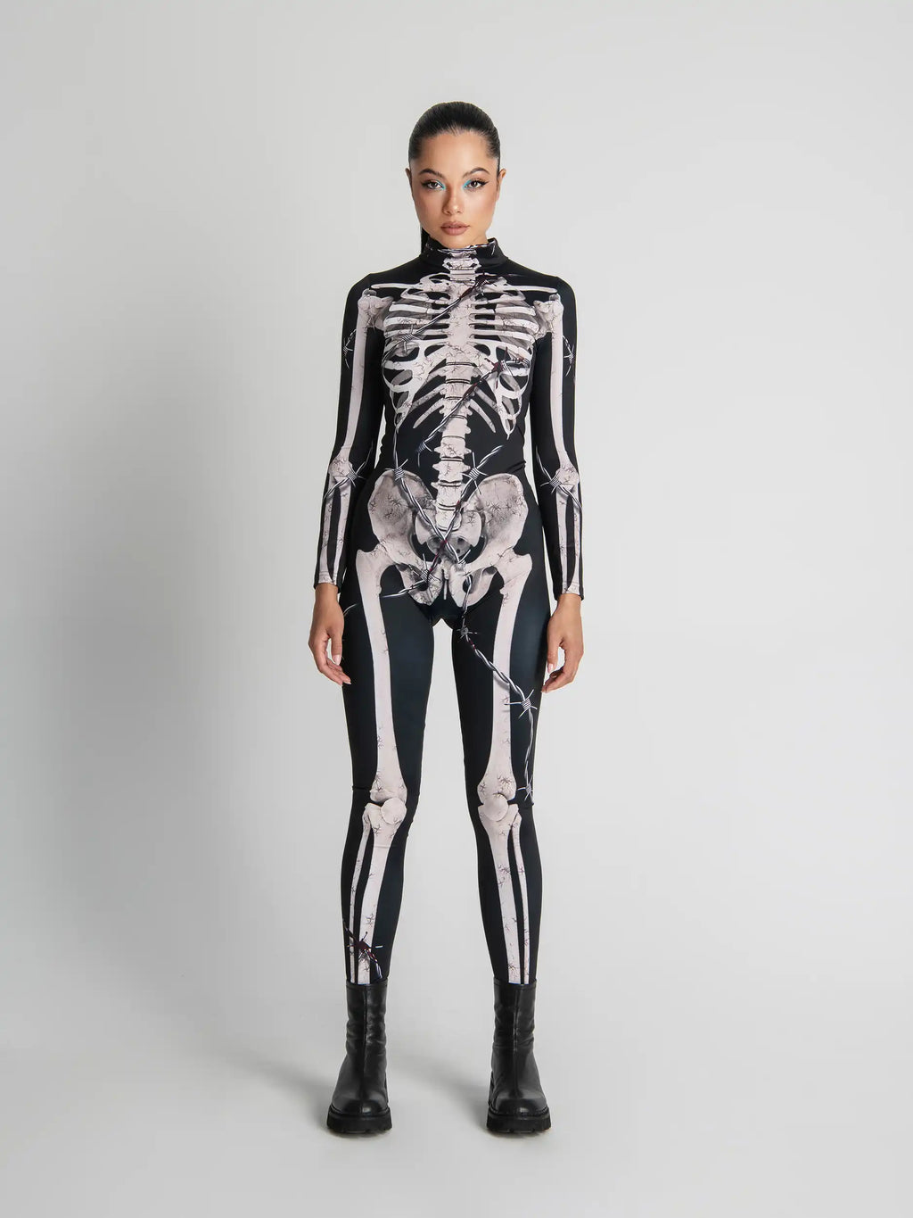 Person wearing a black skeleton-themed bodysuit on a white background