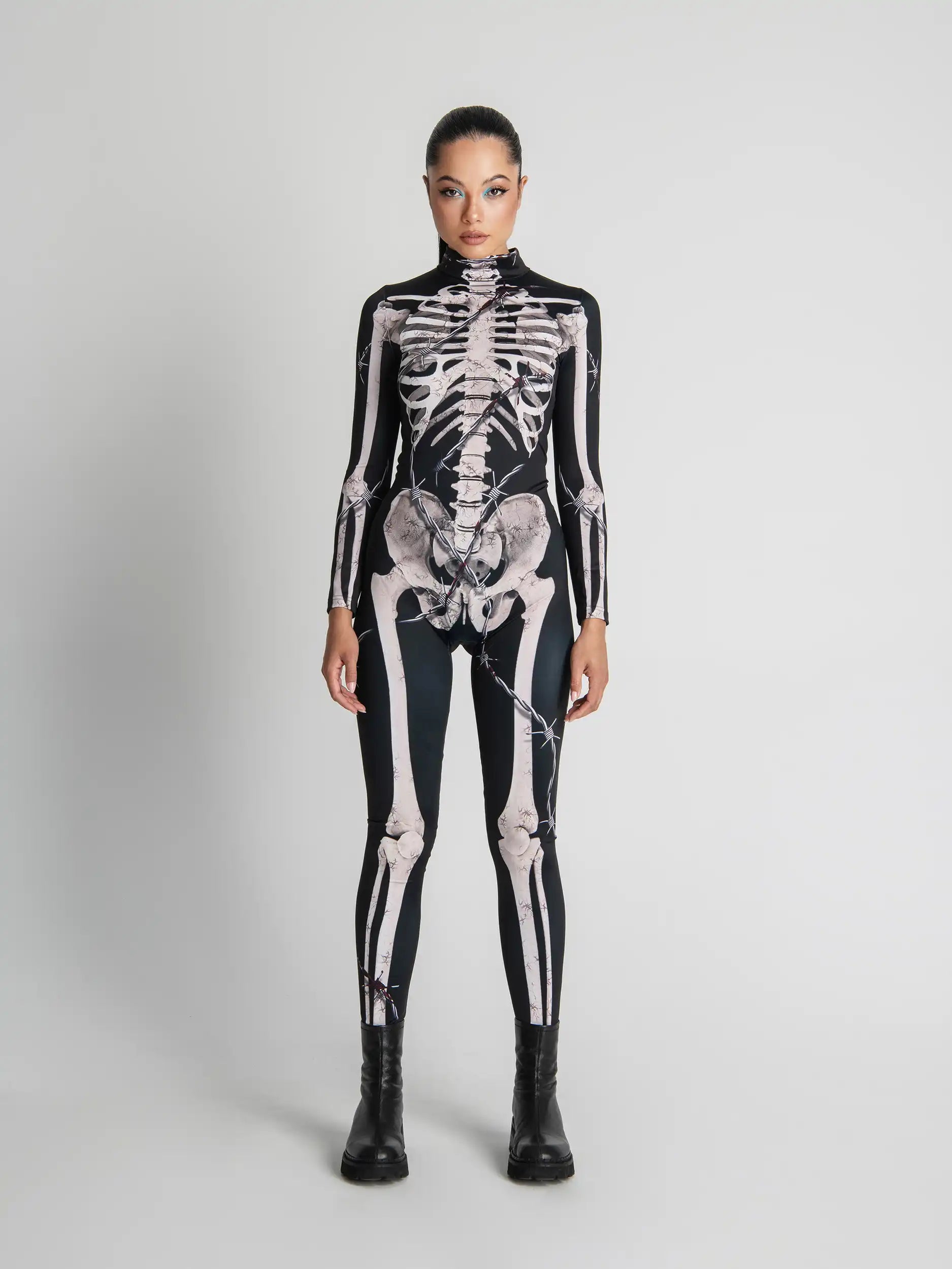 Person wearing a black skeleton-themed bodysuit on a white background