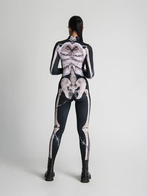 Person wearing a black bodysuit with white skeleton design on a plain background