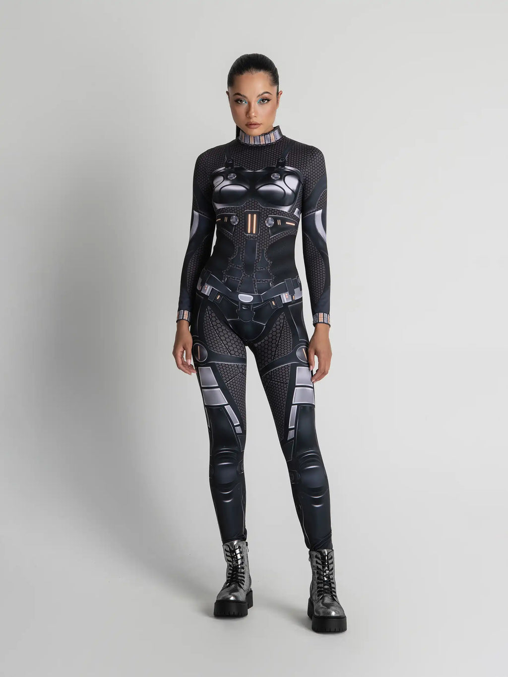 Person wearing a black and gray futuristic suit on a light gray background