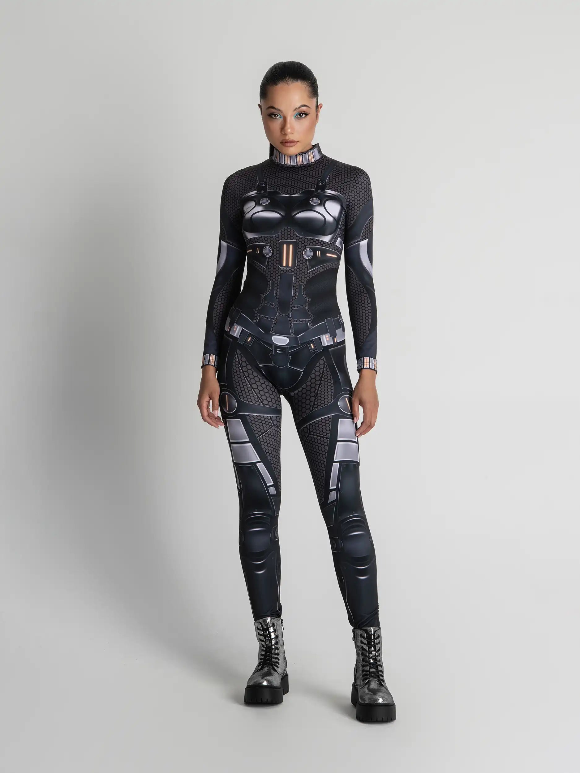 Person wearing a black and gray futuristic suit on a light gray background