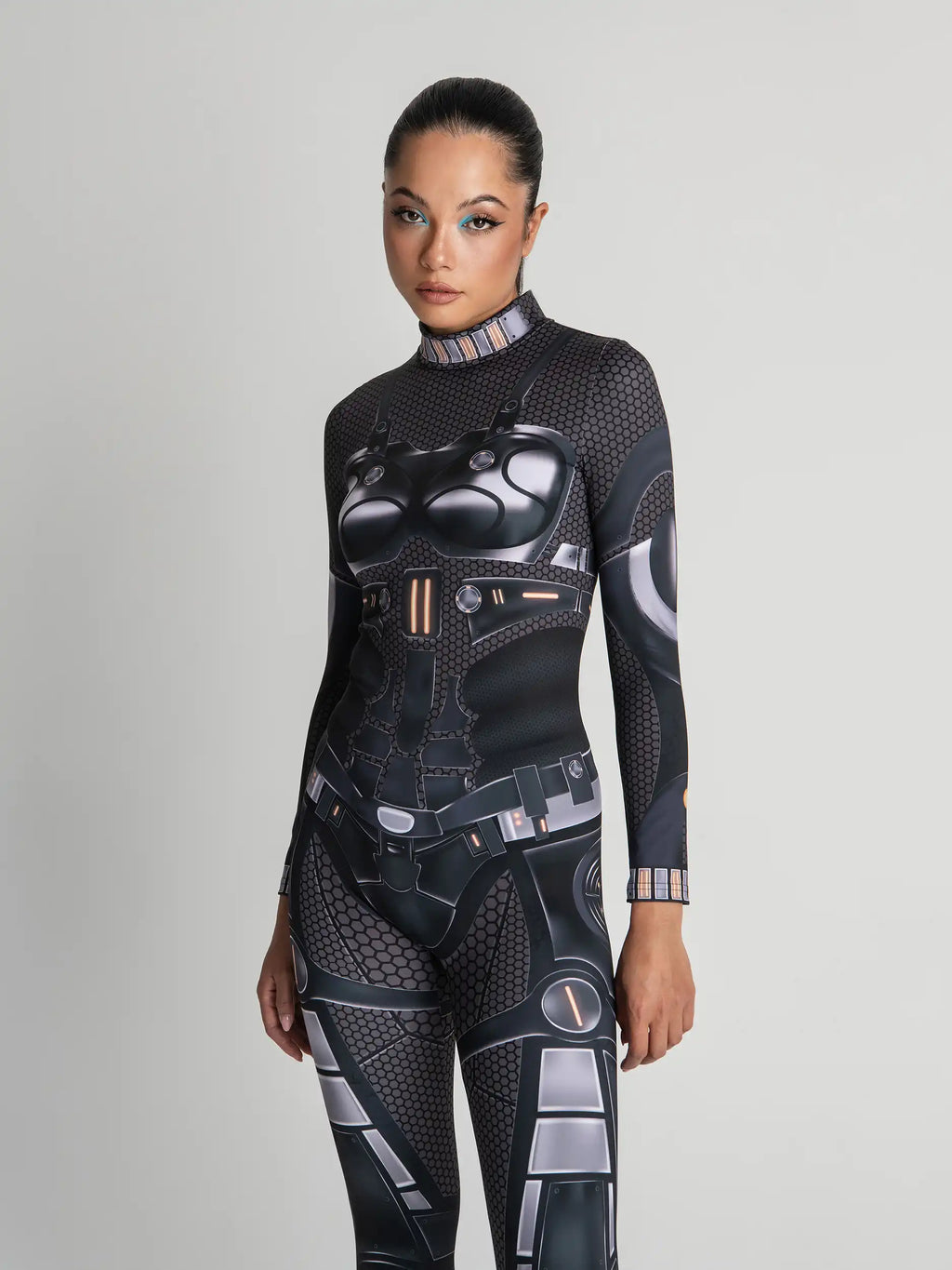 Person wearing a black and gray futuristic bodysuit on a light gray background