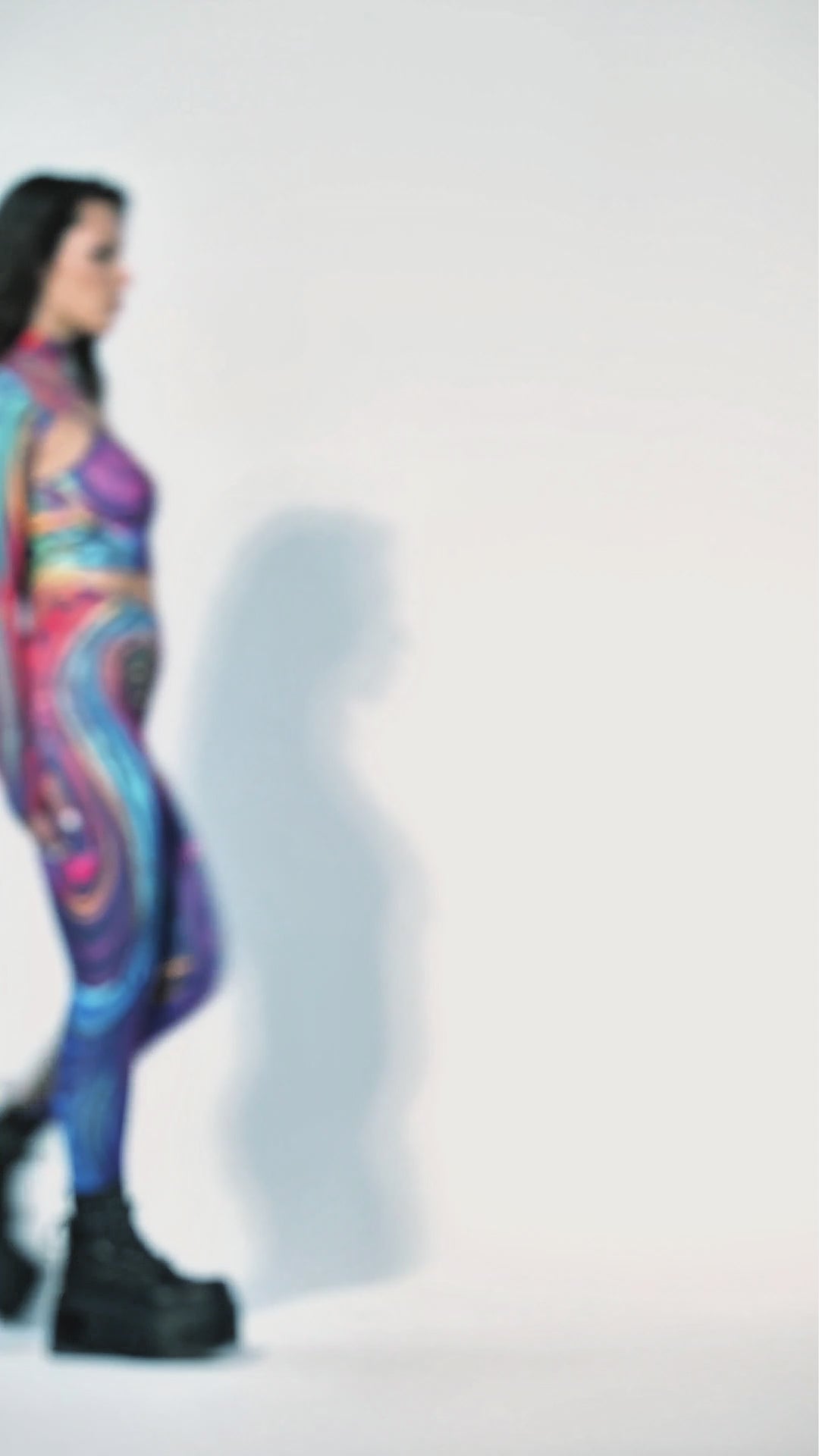 Video of Woman wearing psychedelic three piece rave set with crop top shrug and leggings